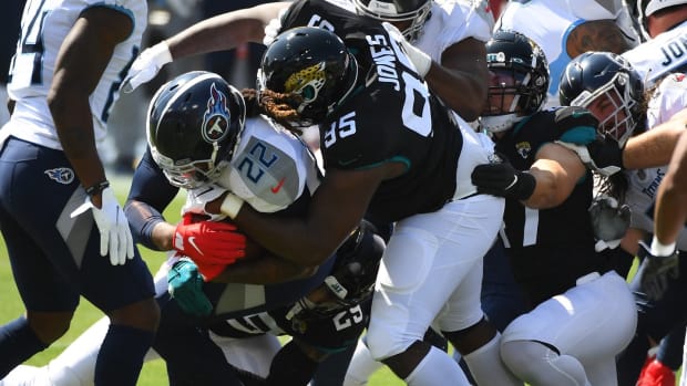 Tennessee Titans running back Derrick Henry (22) is tackled by Jacksonville Jaguars defensive tackle Abry Jones (95) during the first half at Nissan Stadium.
